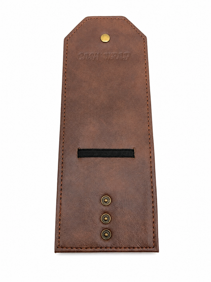 A brown leather money clip with a black elastic band, brass snap buttons, and a brass rivet on a white background.