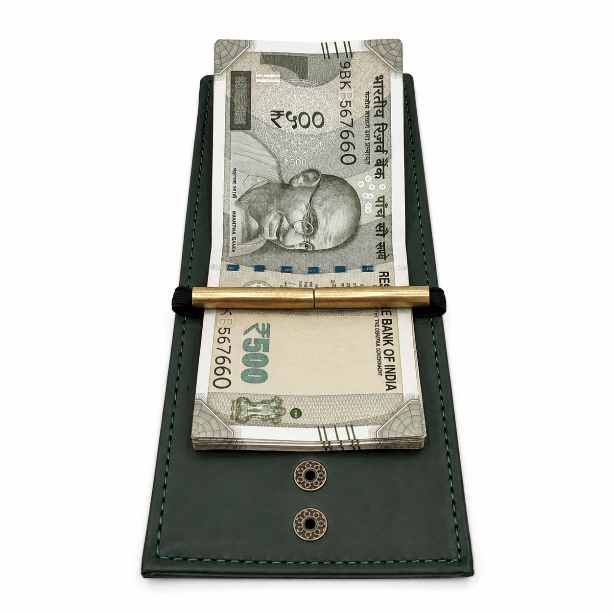 A dark green leather money clip wallet holding two Indian Rupee banknotes and a gold pen, shown on a plain white background.