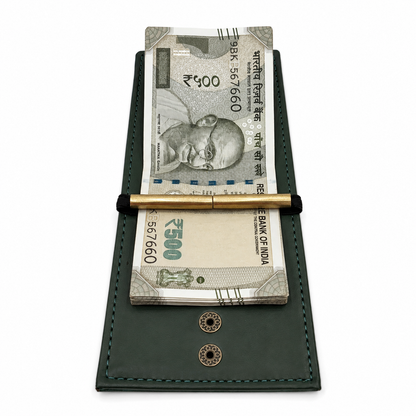 A dark green leather money clip wallet holding two Indian Rupee banknotes and a gold pen, shown on a plain white background.