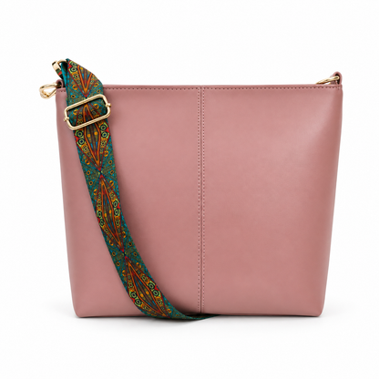 A dusty pink leather shoulder bag with a wide, adjustable patterned strap in teal, orange, and gold, and gold-tone hardware, shown on a white background.