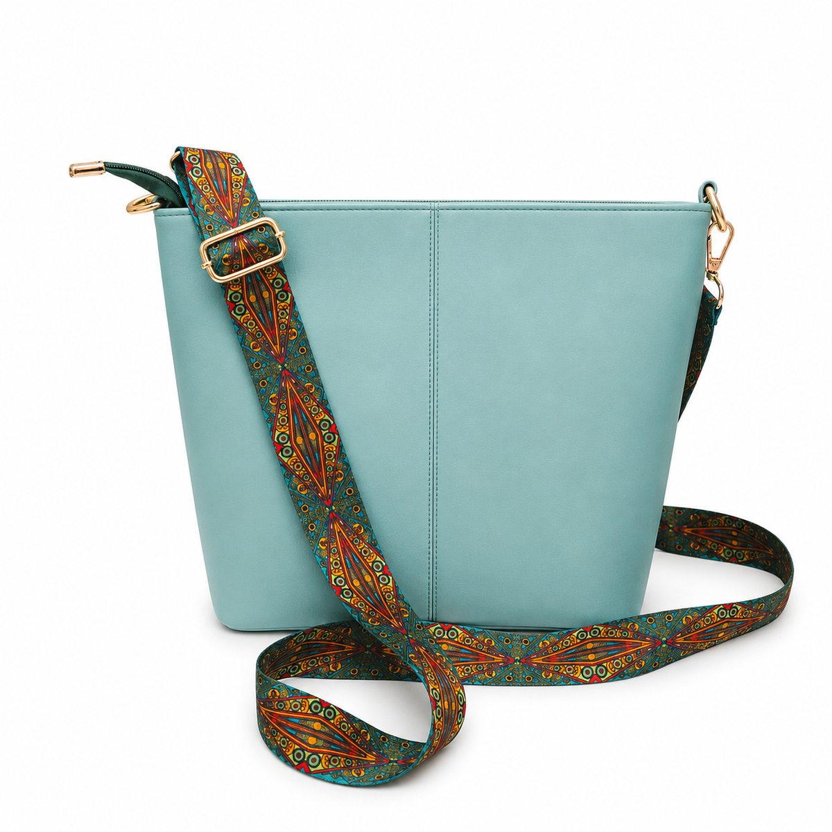 A light blue leather bucket bag with a wide, adjustable shoulder strap featuring a colorful geometric pattern in red, orange, and green, set against a plain white background.