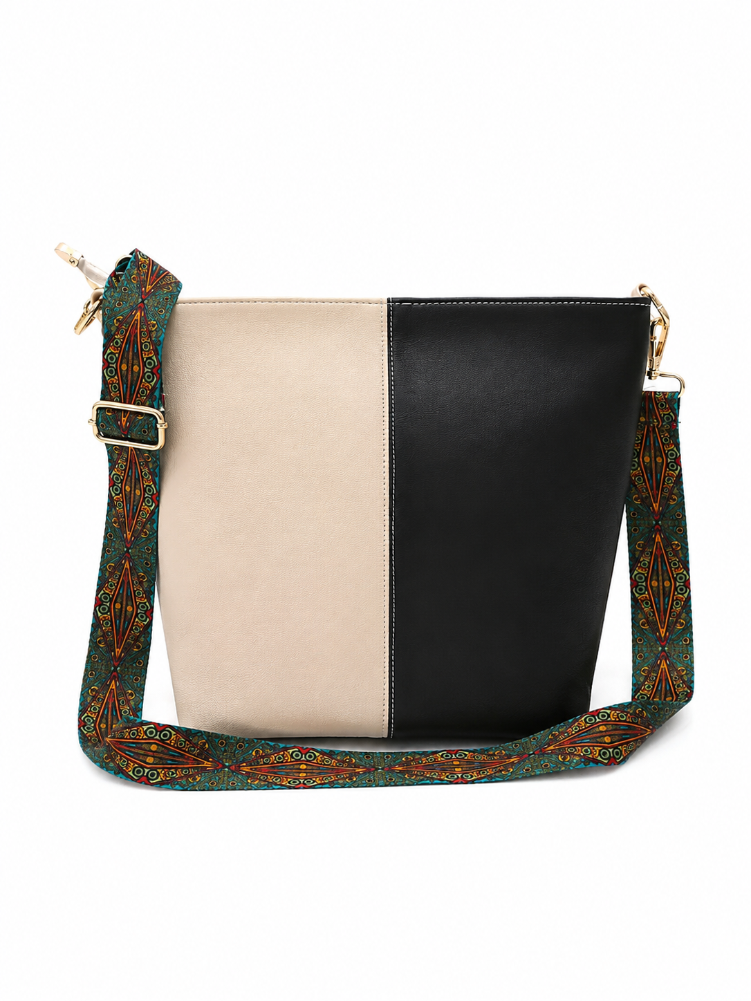 A color-blocked bucket bag with a beige and black front panel, featuring a wide green patterned shoulder strap with gold and orange details and gold-tone hardware.