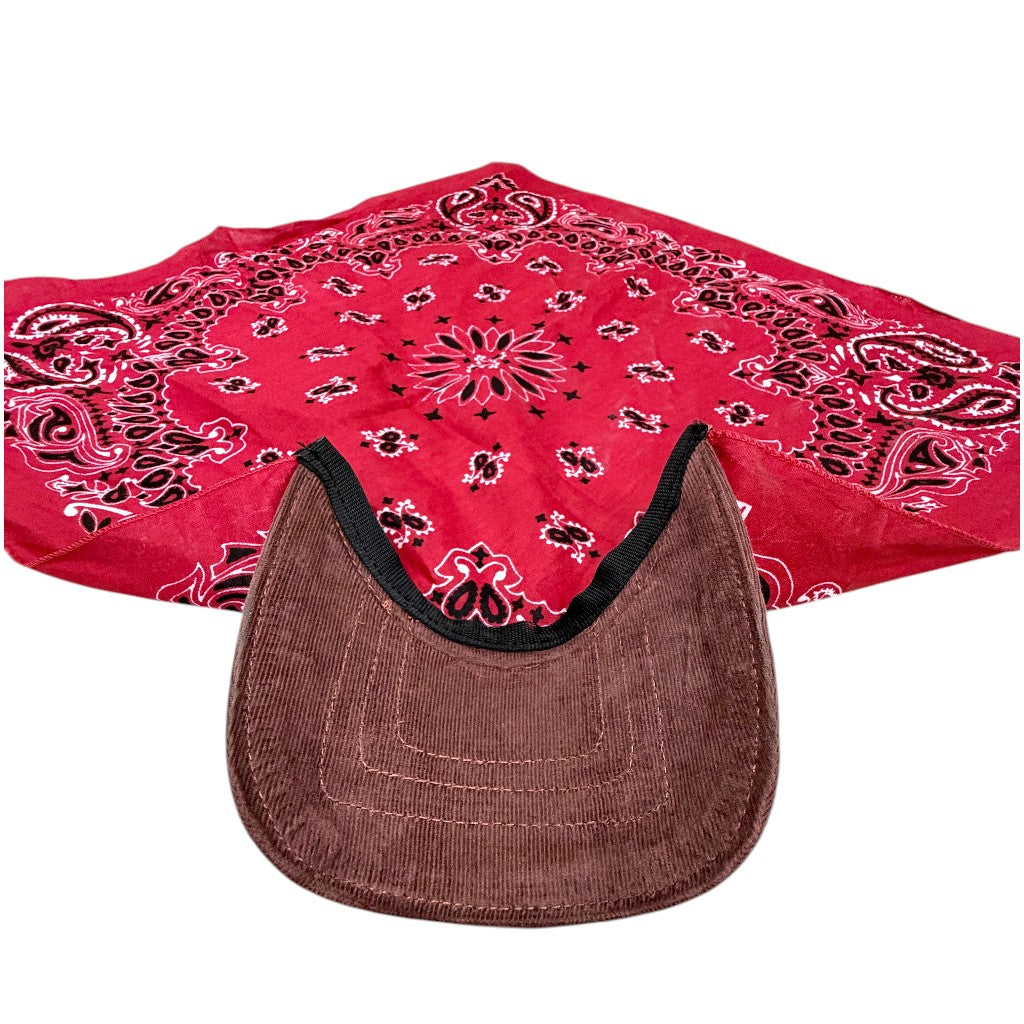 A red paisley bandana with black and white detailing, laid out behind a brown corduroy cap with a black trim, on a plain white background.